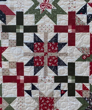 
                  
                    Holiday-themed throw quilt featuring star patterns
                  
                