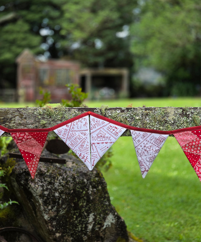 Cheerful handmade Christmas bunting with red and white fabric pennants